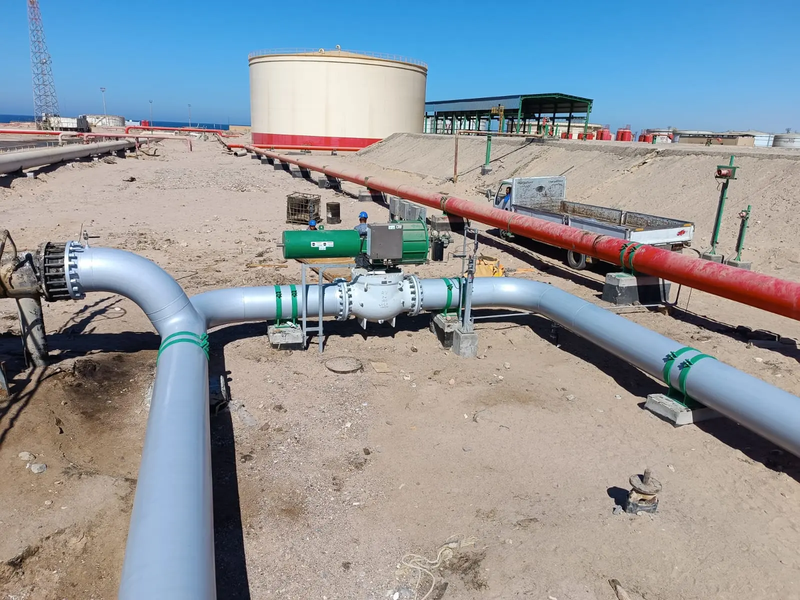 Finished process piping and valves running toward storage tanks