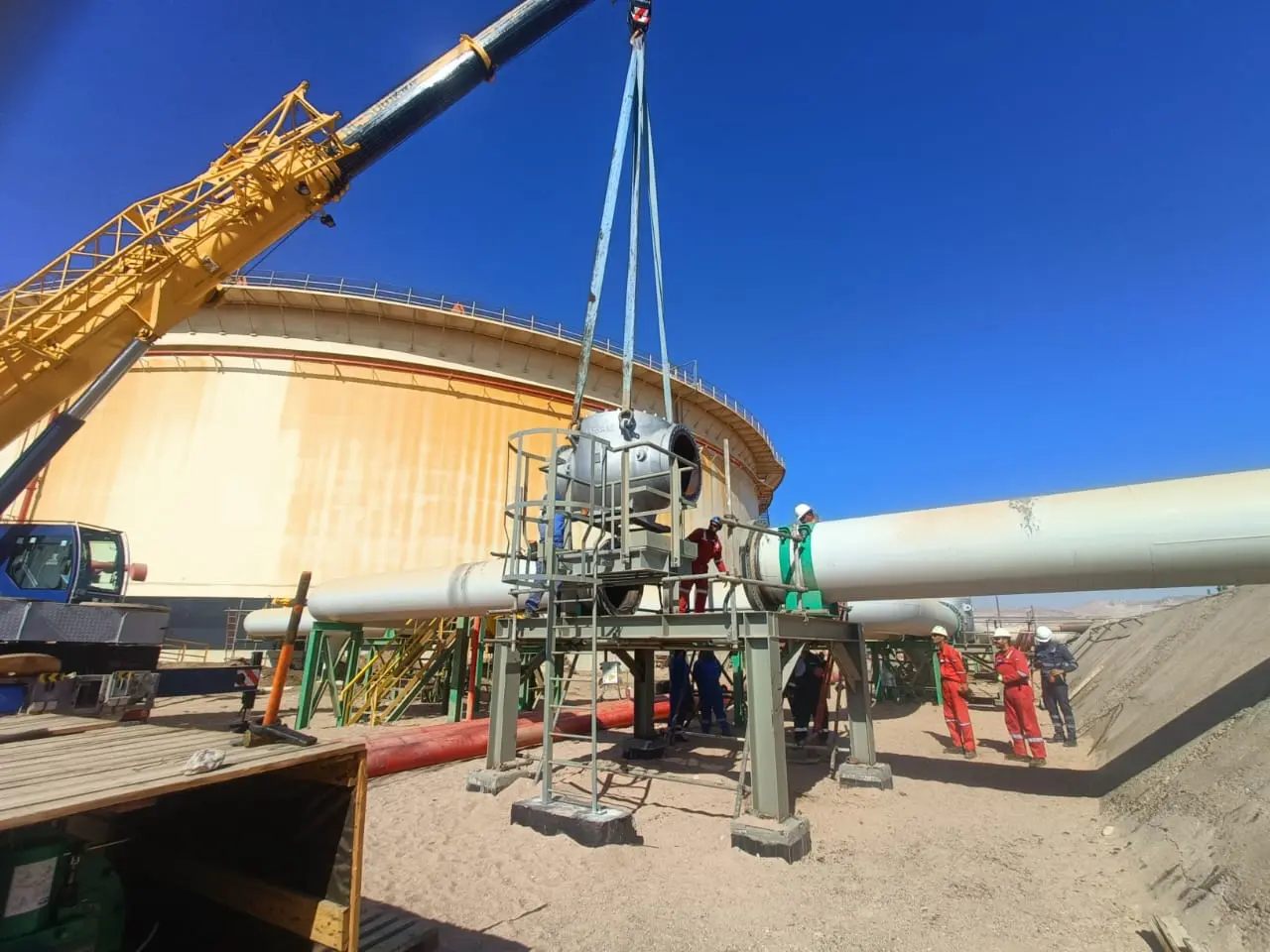 Crane lowering an ESD valve into position at the tank farm