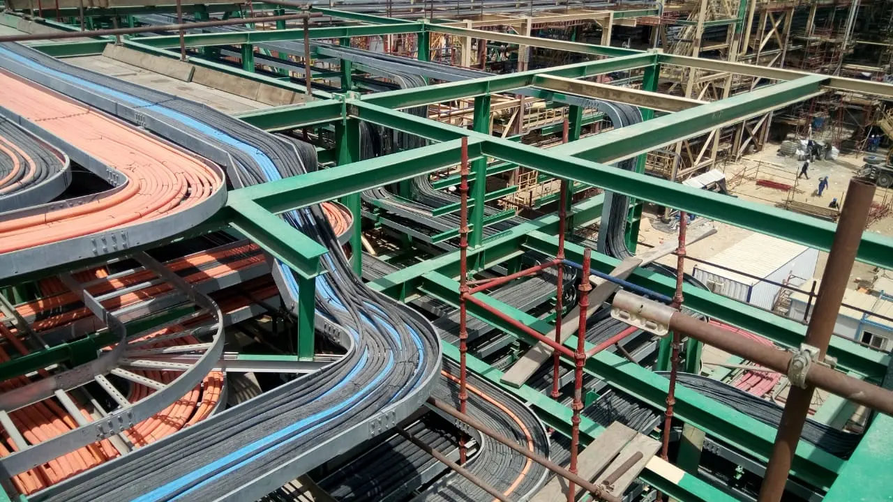 Cable trays branching across a pipe rack