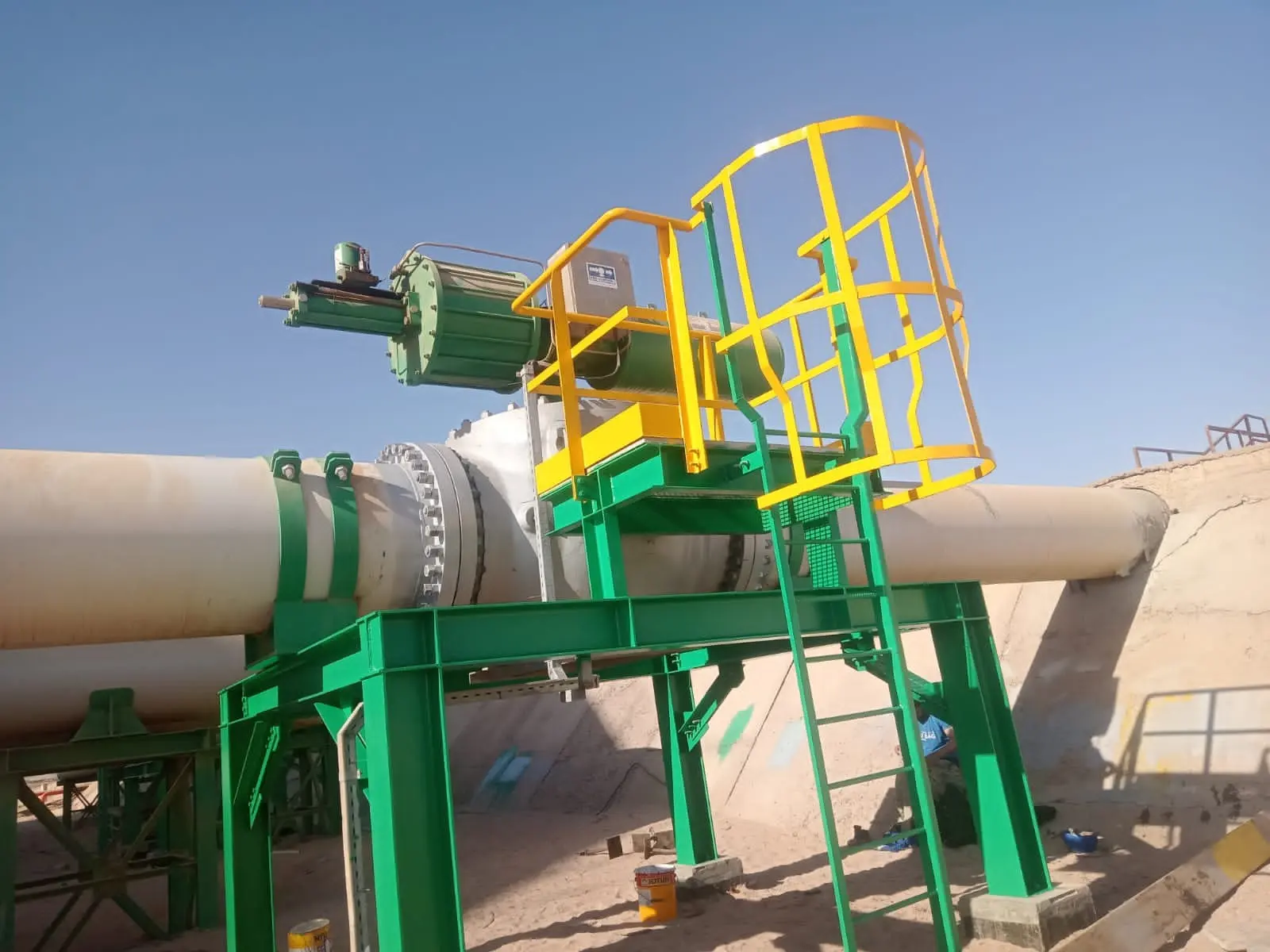 Large pipeline with a newly installed valve access platform on green steel supports