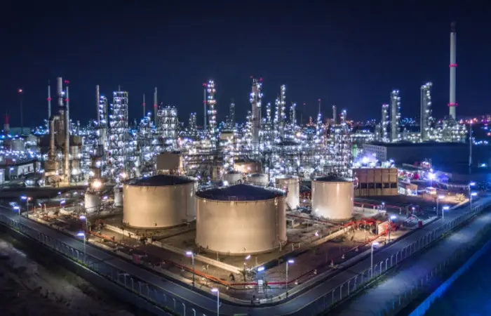 Refinery and storage tanks lit up at night